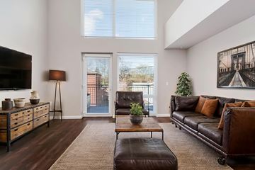 Seattle apartment for rent - A living room with a brown leather couch and a wooden coffee table.