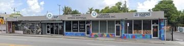 Miami apartment for rent - A row of stores including Colinon Express Service, Lambda Miami-Dade Inc., and Les Vagabonds.