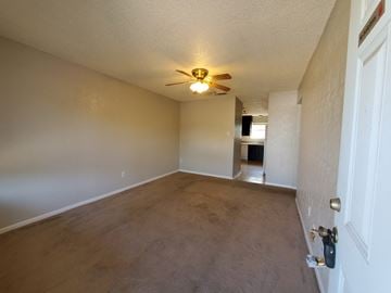 Temple apartment for rent - an empty living room with a ceiling fan