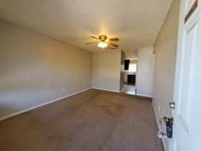 Temple apartment for rent - an empty living room with a ceiling fan