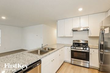 Converse house for rent - a kitchen with granite counter tops and stainless steel appliances