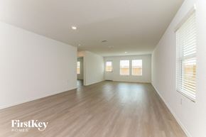 San Antonio house for rent - A spacious room with wooden floors and white walls.