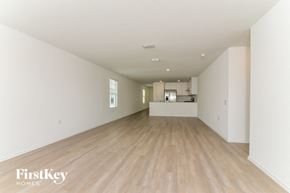 San Antonio house for rent - A spacious room with wooden flooring and white walls.