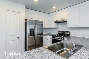 Saint Hedwig house for rent - a kitchen with a sink and a refrigerator