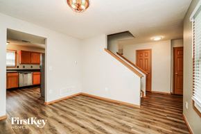 Orient house for rent - A room with wooden floors and a staircase leading to another room.