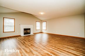 Orient house for rent - A spacious room with wooden floors and a fireplace.