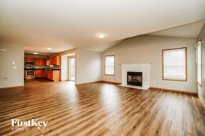 Orient house for rent - A spacious living room with wood flooring and a fireplace.