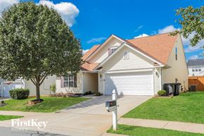 Winston Salem house for rent - a white house with a driveway and a garage door