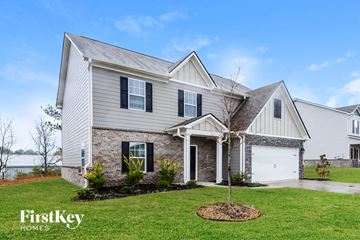Cartersville house for rent - a white house with a white garage and a lawn
