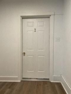 Clairton apartment for rent - A white door with a gold handle is in a room with a wooden floor.