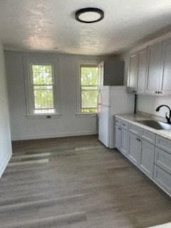 Clairton apartment for rent - A kitchen with white cabinets and a window.