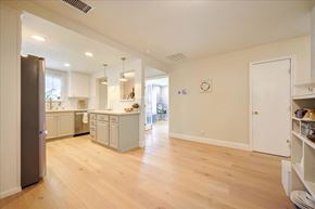 San Jose house for rent - a kitchen and living room with wood floors and a refrigerator