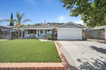 San Jose house for rent - a house with a lawn and a white garage door