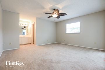 Port Charlotte house for rent - a living room with a ceiling fan and a white carpet