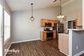 Dallas house for rent - a kitchen with wood flooring and wooden cabinets