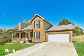 Clarksville house for rent - A brick house with a garage door is for sale.