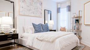Charlotte apartment for rent - a bedroom with white bedding and pillows and a mirror on the wall