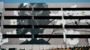 Charlotte apartment for rent - a mural on the side of a building with flowers on it