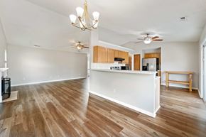Jacksonville house for rent - A kitchen with wooden floors and a white counter.