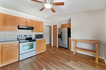 Jacksonville house for rent - A kitchen with wooden cabinets and a stainless steel refrigerator.