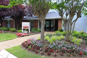 Little Rock apartment for rent - a front yard with flowers and trees in front of a house