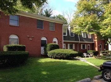 Laporte apartment for rent - a red brick house with a lawn in front of it