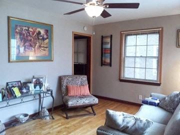 Hammond apartment for rent - a living room with a couch and chair and a ceiling fan