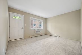 Lombard apartment for rent - an empty living room with a white door and a window