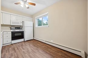 Lombard apartment for rent - an empty kitchen with white appliances and a ceiling fan