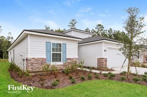 Jacksonville house for rent - a white house with blue shutters on the side of a yard