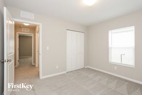 Jacksonville house for rent - a bedroom with a closet and a door to a hallway