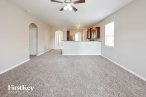 Hockley house for rent - A spacious room with a fan and carpeted floor.
