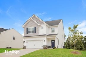 Greenville house for rent - A two-story house with a garage is showcased in the image.