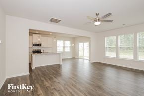 Greenville house for rent - A spacious room with wooden floors and a ceiling fan.
