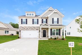 Greenville house for rent - a white house with a lawn in front of it