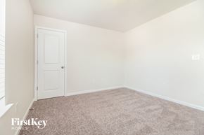 Greenville house for rent - a bedroom with a carpeted floor and a white door