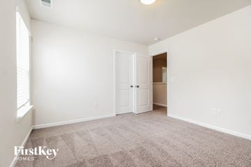 Greenville house for rent - a spacious living room with carpet and a door to a closet