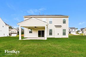 Greenville house for rent - the front of a white house with a porch and green grass