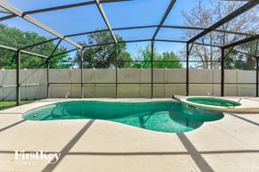 Davenport house for rent - a pool in a screened in pool house with a hot tub