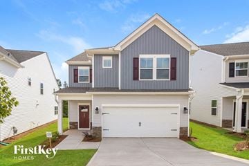 Simpsonville house for rent - a white and gray house with a white garage door