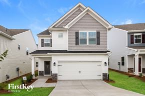 Simpsonville house for rent - A house with a garage and a driveway in front of it.