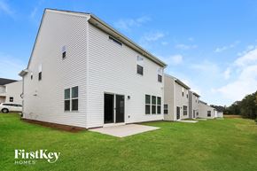 Simpsonville house for rent - A white building with the words "FirstKey Homes" on a sign in front of it.