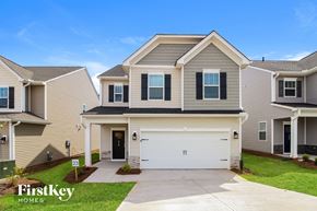 Simpsonville house for rent - a beige house with a white garage door