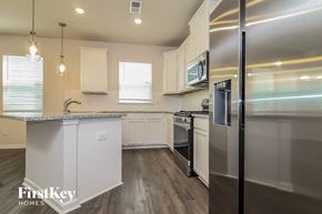 Simpsonville house for rent - a kitchen with stainless steel appliances and white cabinets