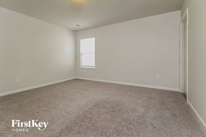 Simpsonville house for rent - a bedroom with a carpeted floor and a window