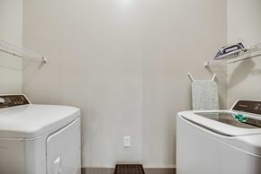 Frisco house for rent - a white laundry room with a washer and dryer and a sink