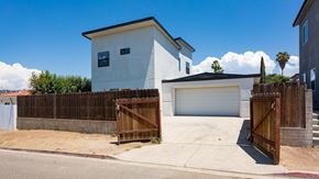 San Diego house for rent - a white house with a wooden fence and a driveway