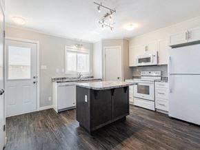 Saskatoon apartment for rent - a kitchen with white appliances and a counter top