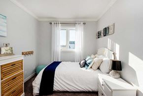 Saskatoon apartment for rent - a small bedroom with a bed and a window