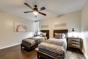 Grand Prairie house for rent - Two beds in a room with a ceiling fan.
